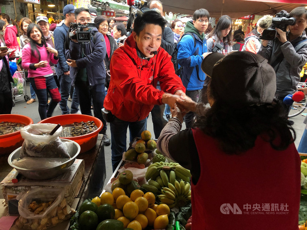 國民黨立委蔣萬安19日前往台北市草埔市場謝票,緊握攤販的手。他也表態未規劃參選黨主席,但絕不缺席黨的改造工程。中央社記者王承中攝 109年1月19日