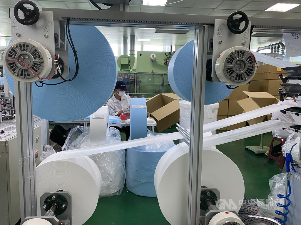 口罩製作需要3種不織布材料,上層兩大捲為口罩外層不織布,下層左邊小捲白色布料為熔噴布,右捲則是貼近口鼻親膚材質不織布。中央社記者潘羿菁攝 109年3月29日