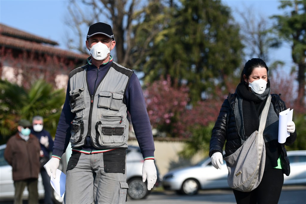 法新社彙整的官方紀錄顯示,截至台灣5日晚間7時,全球感染武漢肺炎死亡人數增至6萬5272例。圖為義大利民眾戴口罩防疫。(法新社提供)