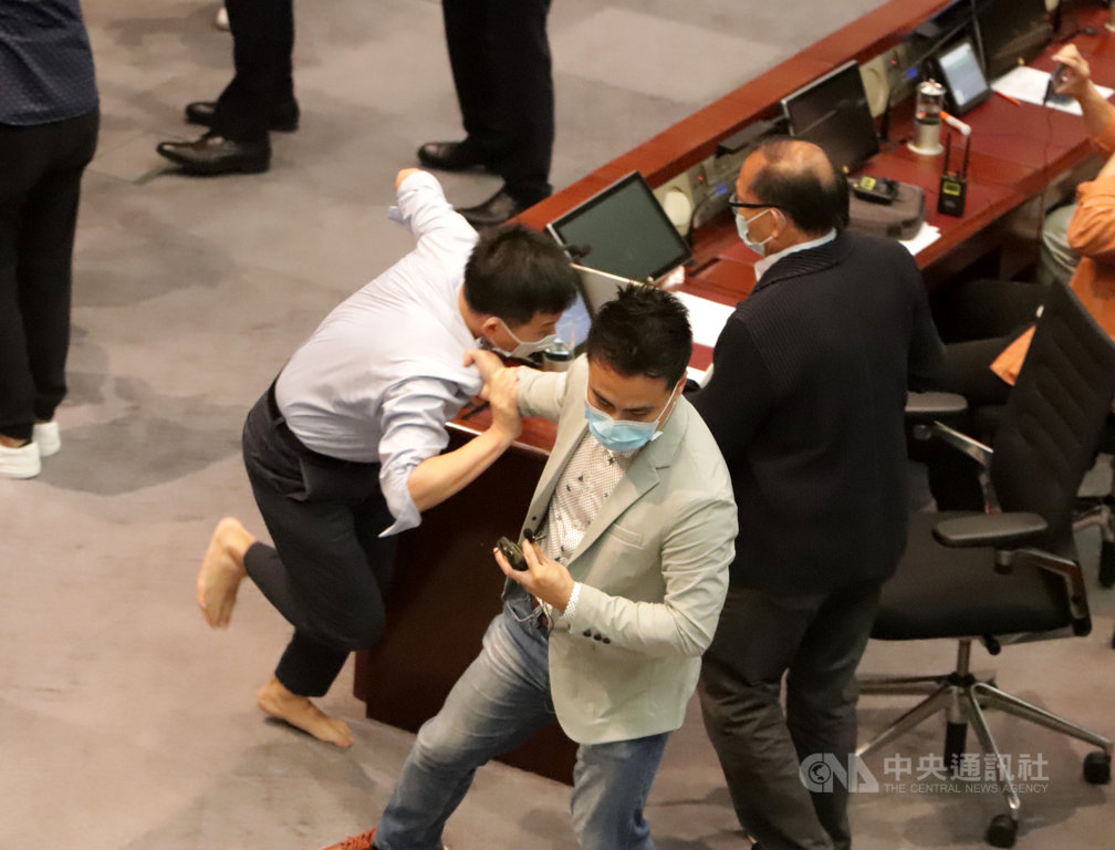 香港7名泛民主派人士11月1日被警方指5月8日於立法會內務委員會會議期間,涉嫌違反「立法會(權力及特權)條例」為由拘捕,包括現任議員胡志偉、前議員陳志全等人。圖為5月8日陳志全被建制議員單手強行拖走。(中央社檔案照片)