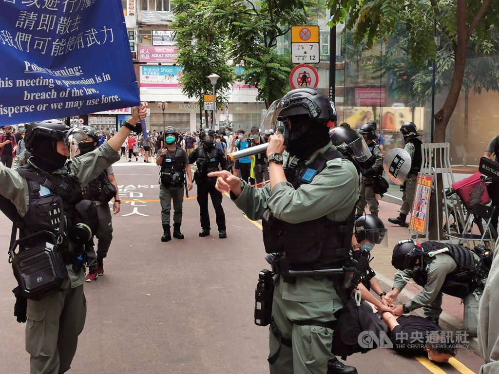 「港區國安法」6月30日深夜生效後,不少港人7月1日在銅鑼灣崇光百貨一帶遊行抗議。圖為下午2時許,警方驅趕附近聚集的人士,並逮捕一名示威者。中央社記者張謙香港攝 109年7月1日