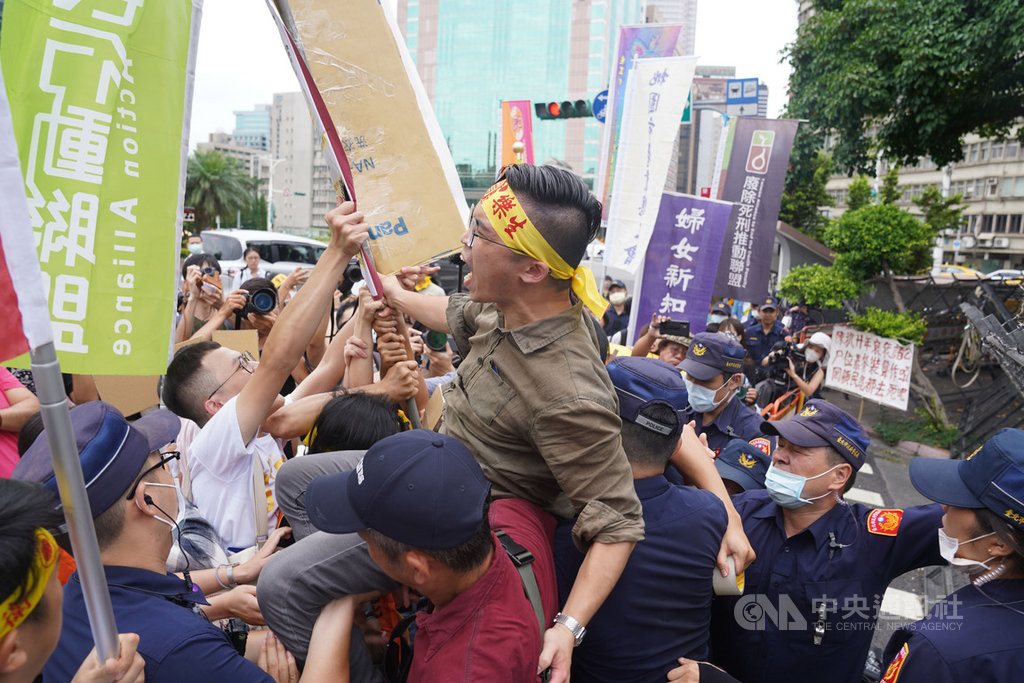台北高等行政法院7日宣判「樂生懸空陸橋入口環評案」假處分裁定停工。樂生保留自救會與青年樂生聯盟9日前往行政院前抗議,呼籲政府機關尊重司法、放棄抗告。圖為抗議民眾與警方發生短暫推擠衝突。中央社記者徐肇昌攝 109年7月9日