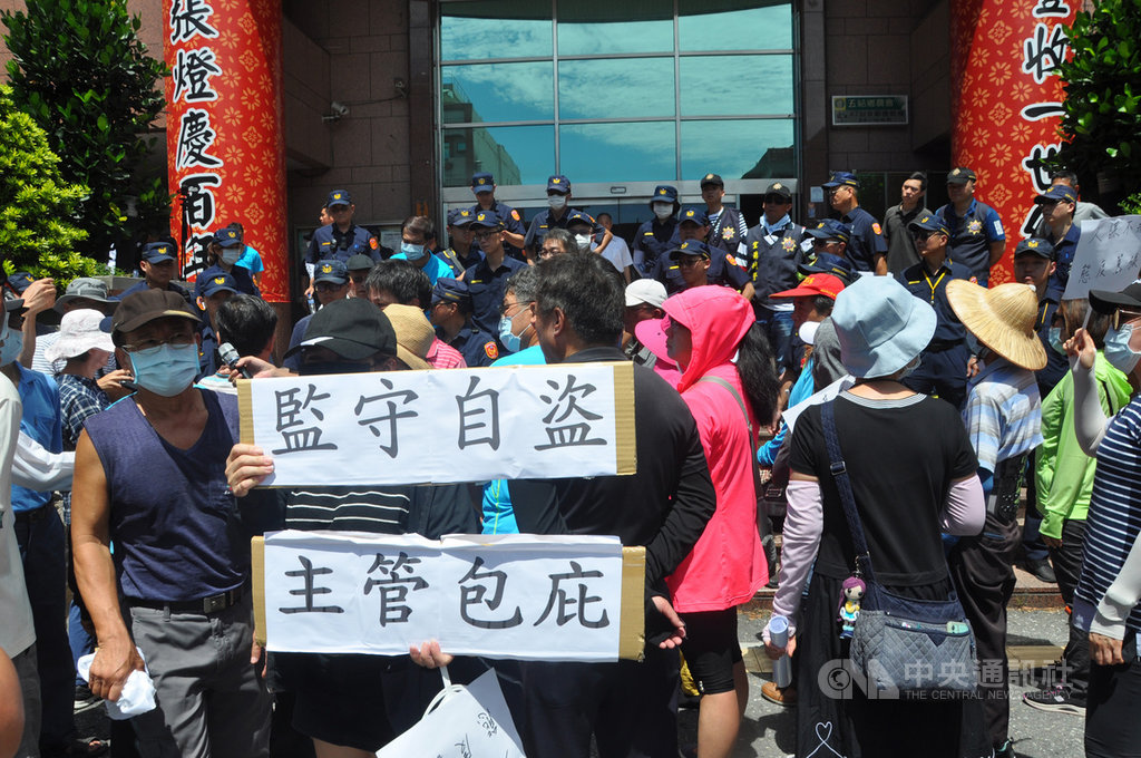 宜蘭五結鄉農會4月爆發員工涉嫌保管箱監守自盜,約有50人受害。受害者因不滿理賠方式,10日前往農會舉起「監守自盜、主管包庇」的紙板抗議,警方出動大批警力維持秩序。中央社記者沈如峰宜蘭縣攝 109年7月10日