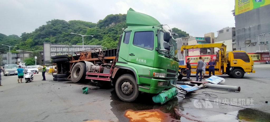 楊姓男子15日上午駕駛貨櫃車行經台62甲線匝道時,疑煞車失靈導致貨櫃車翻覆,號誌桿受到劇烈撞擊應聲斷裂,現場留下大片油漬,所幸無人受傷。中央社記者王朝鈺攝 109年7月15日