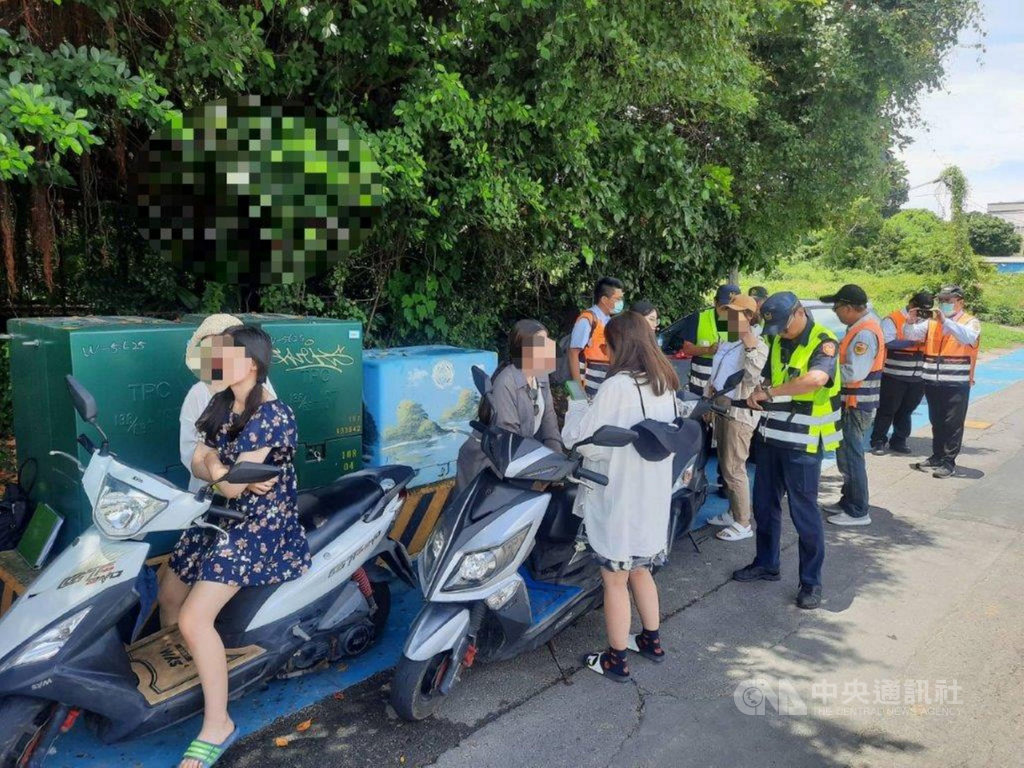 國內疫情趨緩,暑假屏東小琉球遊客暴增,騎機車不戴安全帽、違規停車等亂象叢生,警方取締交通違規,一攔就是一整群結群騎出租機車沒戴安全帽的遊客。中央社記者郭芷瑄攝 109年8月1日
