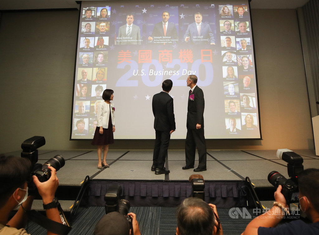 「2020年美國商機日」15日在台北國際會議中心登場,經濟部國貿局長江文若(左起)、貿協董事長黃志芳與美國在台協會台北辦事處處長酈英傑(William Brent Christensen)合影後,觀看投影幕上的美國州政府商務廳官員照片。中央社記者張新偉攝 109年10月15日