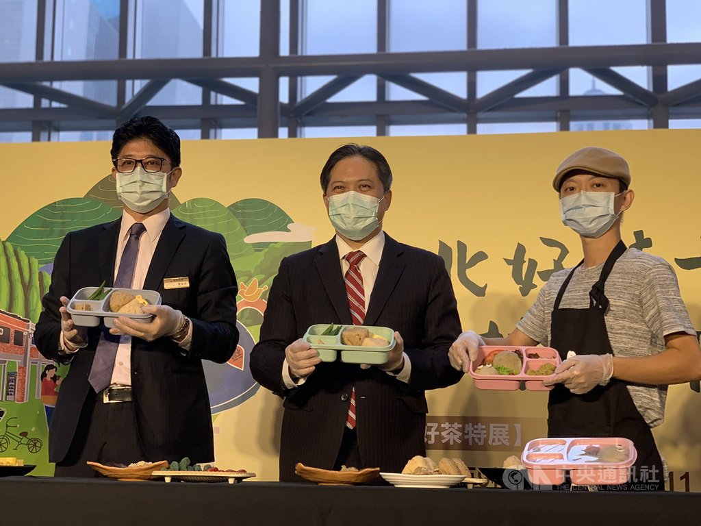新北市副市長吳明機(中)27日出席十冠茶特展開展記者會,現場體驗製作特色便當。中央社記者沈佩瑤攝 109年11月27日