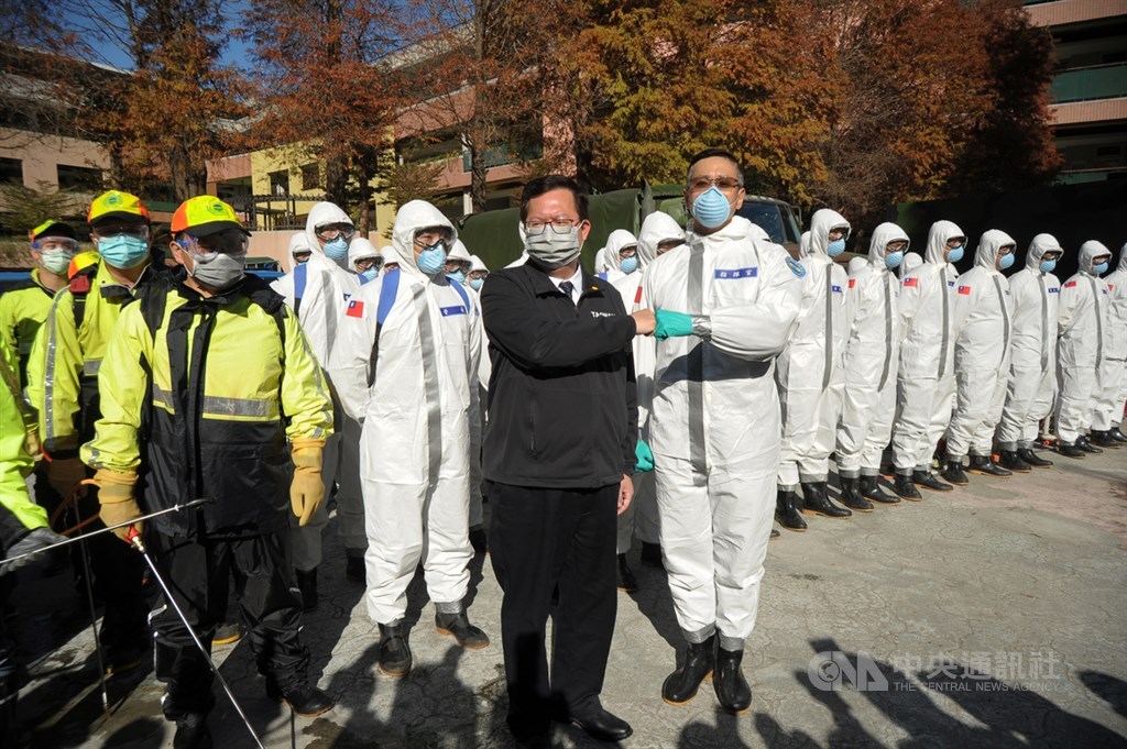 桃園市長鄭文燦(前左)21日前往視察桃醫周邊社區環境清潔消毒作業情形,與前來幫忙的國軍化學兵及環保局工作人員一起加油打氣。中央社記者施宗暉攝 110年1月21日