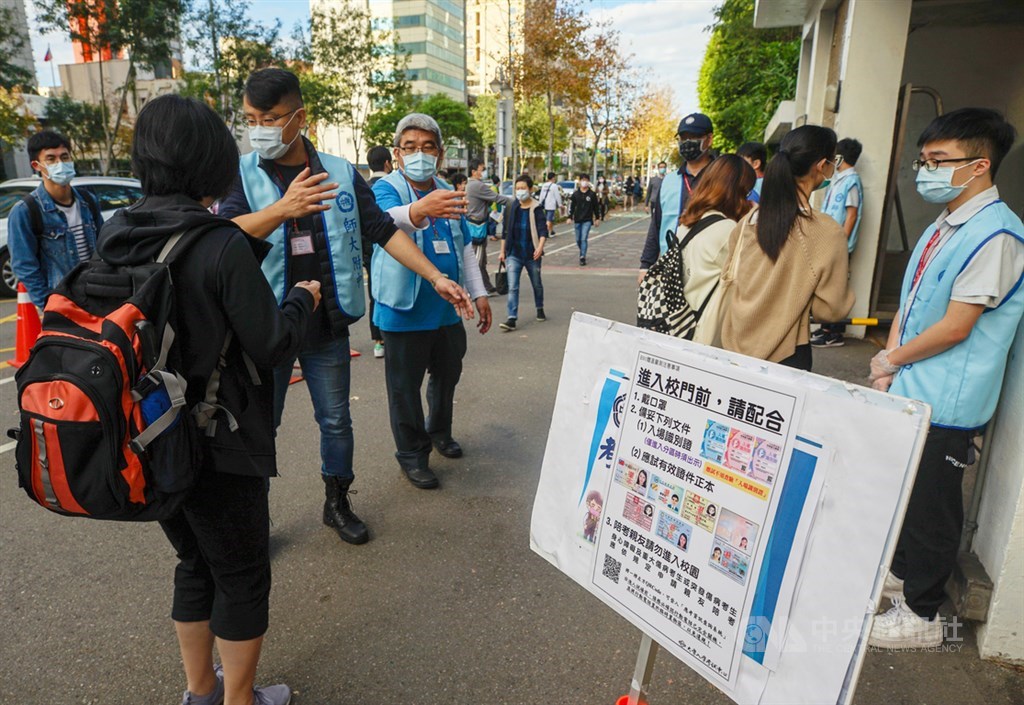 110學年度學科能力測驗22日登場,為配合防疫,試務人員在門口一一檢查考生身分證件及入場識別證。中央社記者裴禛攝 110年1月22日