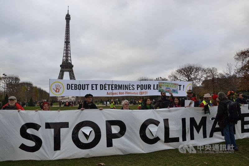 巴黎氣候協定今天終於正式通過，數千人聚集在艾菲爾 鐵塔前，要求一份更具抱負的協議，並呼籲停止「氣候 犯罪」，落實減碳承諾。 中央社記者曾依璇巴黎攝 104年12月13日