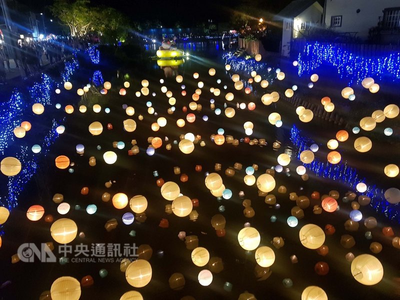 農曆過年期間,不少民眾造訪台南鹽水的「月津港燈節」,其中一件作品「行星計畫」,將大大小小的燈籠吊掛在河面上,夜晚時配合燈光投射、倒影映照,優美的畫面成為不少民眾拍照、打卡熱點。中央社記者鄭景雯攝 108年2月18日