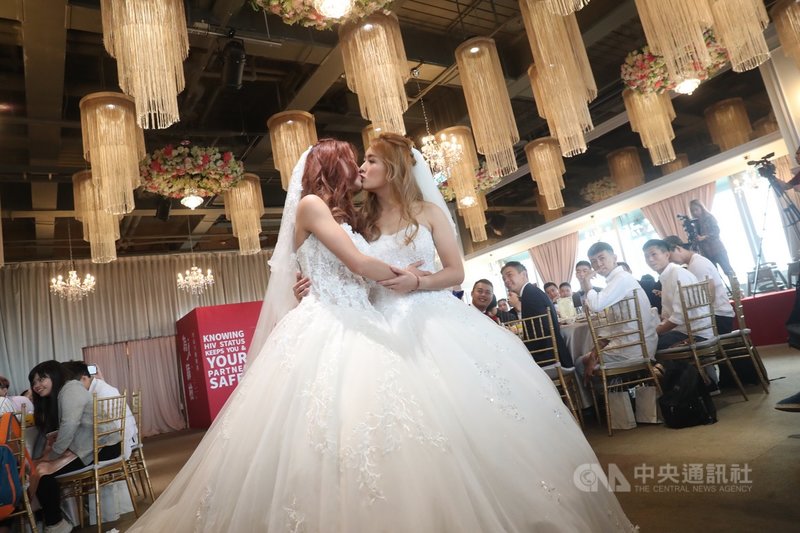 同婚專法過關，首場婚姻平權婚禮18日登場，同性伴侶穿上白紗，在眾人見證下親吻，接受大家的祝福。中央社記者吳家昇攝　108年5月18日