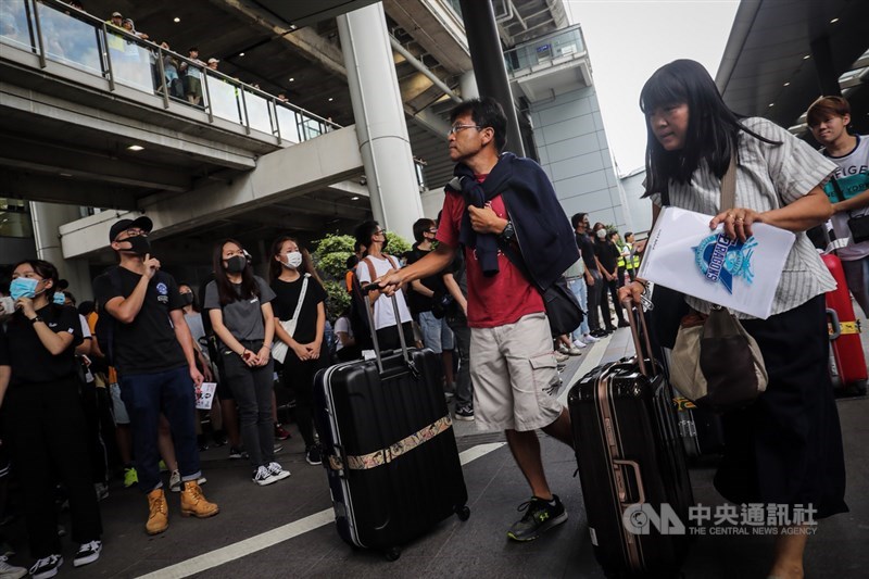 反對修訂逃犯條例網民呼籲其他人於1日下午1時參加「機場交通壓力測試」行動,中午過後有市民響應,開始在香港機場巴士總站聚集,有旅客不受影響,推著行李進入機場。中央社記者吳家昇攝 108年9月1日