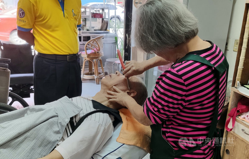 縱使行動不便,90歲的吳姓老翁(左)每個月堅持要讓79歲的理髮師傅韓梅子(右)剪頭髮,不僅信賴,還有50餘年的交情。中央社記者盧太城台東攝 108年10月15日