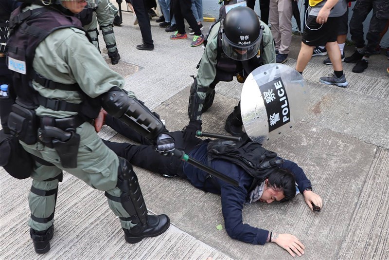 香港教育局近期提供意見並修訂高中通識科教材,刪除部分政治內容,包括「公民抗命」及「三權分立」等,並增加「遵守法治」概念,相信此舉與「反送中」運動有關。圖為2019年8月24日,香港反送中示威行動,警方施放催淚彈並動手抓人。(中央社檔案照片)