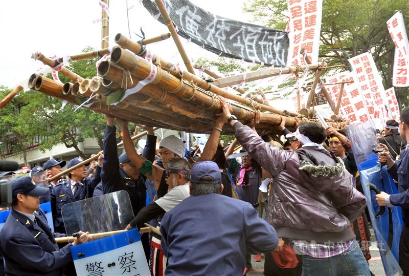 民國 101年12月22日下午,台東美麗灣渡假村進行第7次環評,環團扛著竹筏欲進入會場,遭警方人牆阻擋,爆發衝突。(中央社檔案照片)