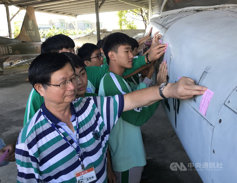 飛官上校蔣正志17日晚間駕駛F-16戰機失聯迄今,花蓮上騰工商飛機修護科因曾獲空軍捐贈除役戰機供教學用,校長溫智雄(前左)19日邀請學生一起在戰機機身貼上祈福小卡,為蔣正志集氣。中央社記者張祈攝 109年11月19日