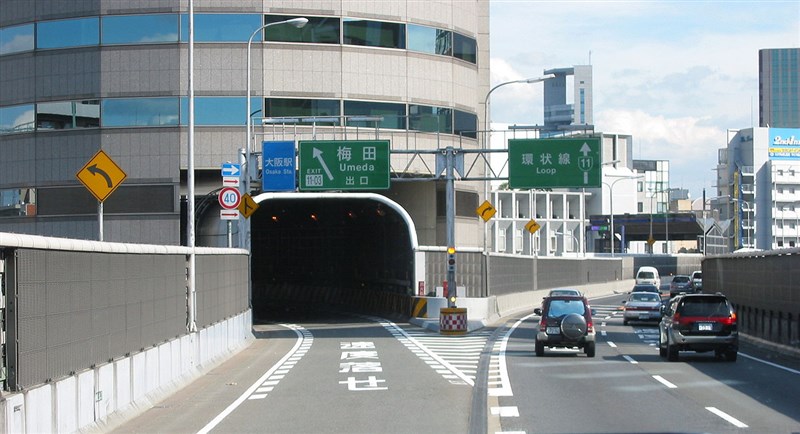 「門塔大廈」在1992年完工,成了全日本第一個利用立體道路制度跟高速公路共存的案例。(圖取自維基共享資源;作者ユニ,CC BY-SA 3.0)