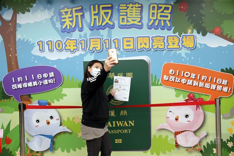 新版護照11日閃亮登場,民眾踴躍換發護照,並自拍打卡。中央社記者郭日曉攝 110年1月11日