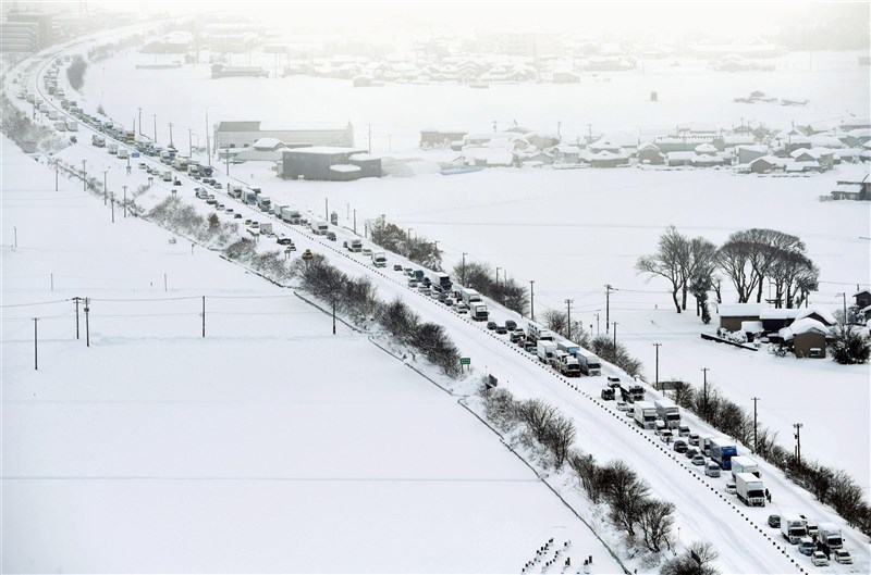 受到冬季氣壓和極強寒流的影響,日本海一側的地區下雪,新潟縣、北陸等地下起紀錄性的大雪,許多車子10日困在福井縣北陸高速公路。(共同社)
