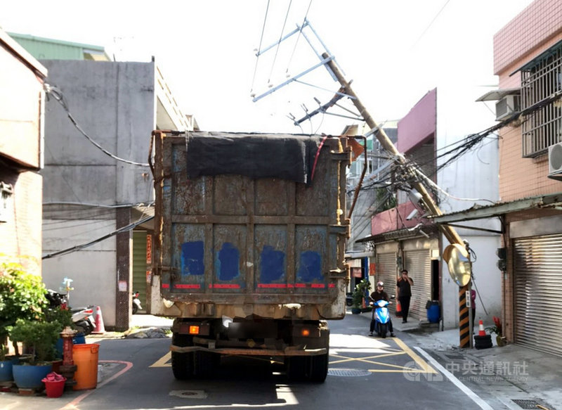一輛聯結車20日行經新北市鶯歌區德昌街時,不慎鉤到電纜並導致電桿斷裂,造成地區局部停電。警方獲報到場實施車輛管制,並通知台電人員到場斷電及搶修。(警方提供)中央社記者黃旭昇新北傳真 110年2月20日