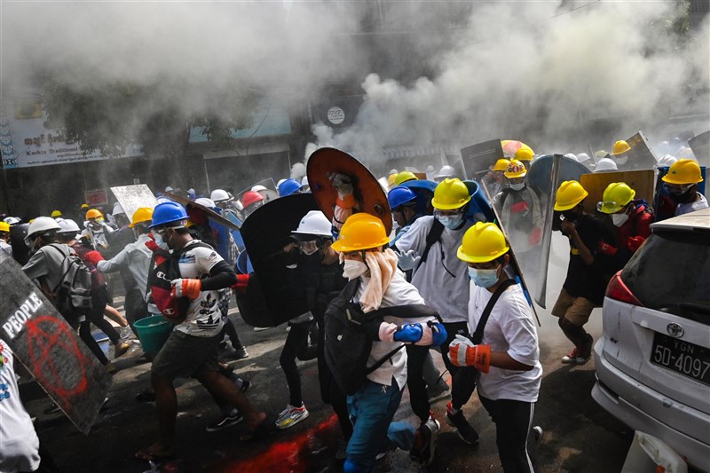 儘管軍警開槍驅離示威者,3日仍有大批緬甸民眾聚集仰光抗議軍方政變。圖為緬甸民眾手持自製盾牌於仰光反政變示威中。(法新社)
