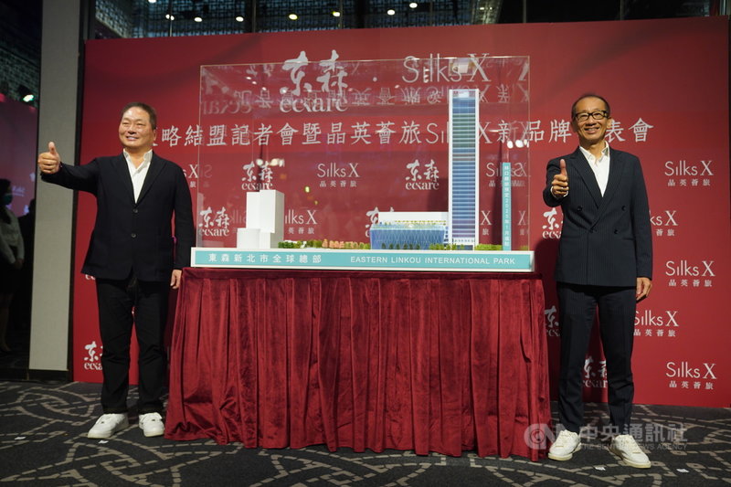 東森.晶華策略結盟暨全新酒店品牌發表會5日在台北晶華酒店舉行,東森集團總裁王令麟(左)與晶華國際酒店集團董事長潘思亮(右)簽約合作,在模型旁合影留念。中央社記者徐肇昌攝 110年3月5日