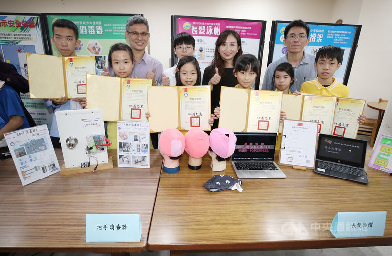 嘉義大學附小學生楊喆媗(前右3)、黃靖琁(前右4)設計「長髮泳帽」在2020世界青少年發明展獲獎,同校學生張耘誠(前右)與張嵐雲(前右2)另以「譜本支撐架」獲肯定,同校還有沈庭羽(前左2)與北興國中同學王冠文(左)合作,以「把手消毒器」獲獎。中央社記者張新偉攝 110年3月12日