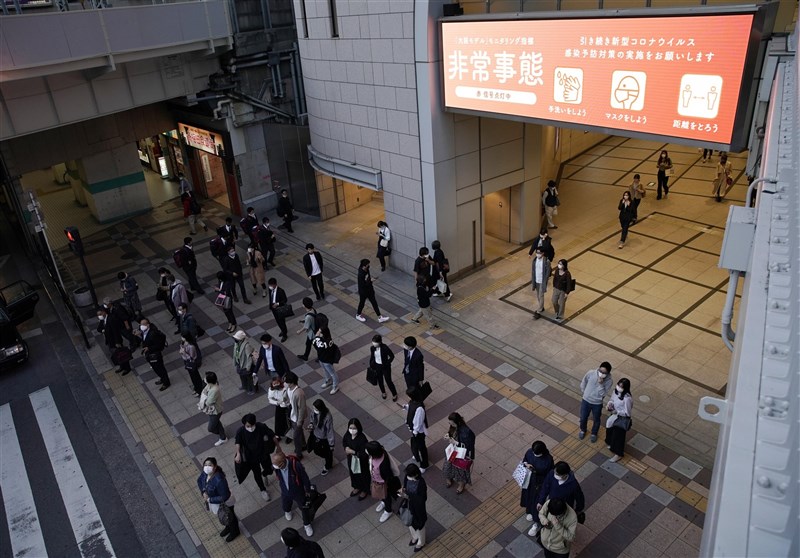 日本政府預定23日晚間將對疫情嚴峻的東京都、大阪府、兵庫縣及京都府4都府縣,正式發布第3度「緊急事態宣言」。圖為大阪民眾22日戴口罩上街。(共同社)