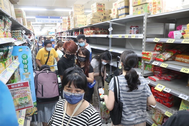 武漢肺炎疫情升溫,台北市、新北市15日起至28日升級第三級警戒,不少民眾上午前往大賣場採買日用品,貨架上的商品幾乎被搶購一空。中央社記者吳家昇攝 110年5月15日