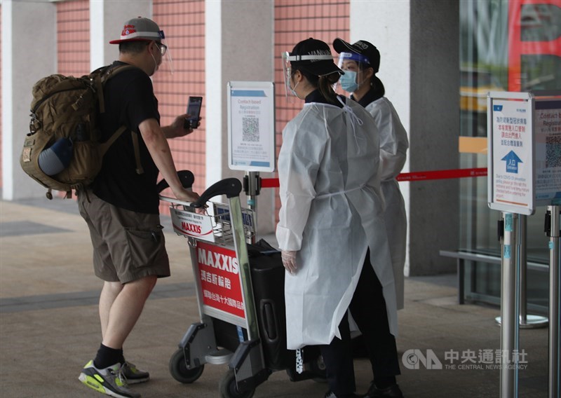 因應疫情,指揮中心公布國內5機場與離島船班將設立採檢站,有症狀旅客須接受採檢,2日起實施。圖為松山機場防疫作業。(中央社檔案照片)