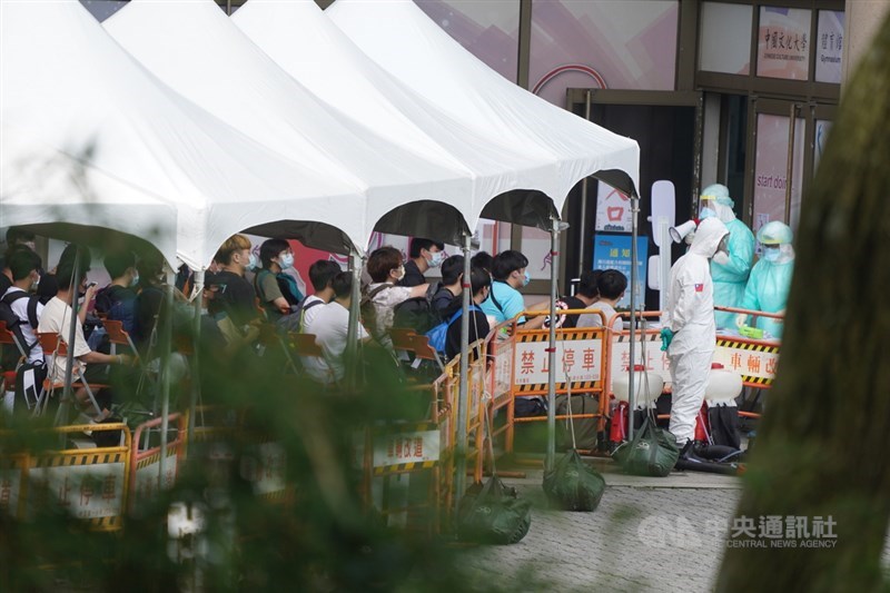 文化大學校內大倫館有4名學生確診武漢肺炎,校方2日安排大倫館住宿生共314人接受快篩,其中14人結果為陽性,已安排住進集中檢疫所。圖為住宿生在快篩場所外等待。中央社記者徐肇昌攝 110年6月2日