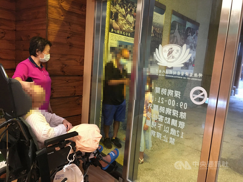 疫情嚴峻,醫院禁止探病,台中慈濟醫院安排病人與家人隔著落地窗見面,住院治療的蓉蓉在玻璃門前與先生及小孩見面,貼心的孩子還準備水果給媽媽,並由護理人員協助轉交,讓蓉蓉相當開心。(台中慈濟醫院提供)中央社記者趙麗妍傳真 110年6月9日