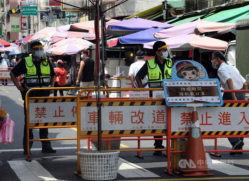 台北3大批發市場武漢肺炎疫情蠢蠢欲動,各界關注12日微解封可能性。指揮中心指揮官陳時中4日重申,解封視疫情控制情況,仍傾向全國一致。圖為台北第二果菜市場外圍攤商4日人流減少,警察駐點執行勤務。中央社記者郭日曉攝 110年7月4日