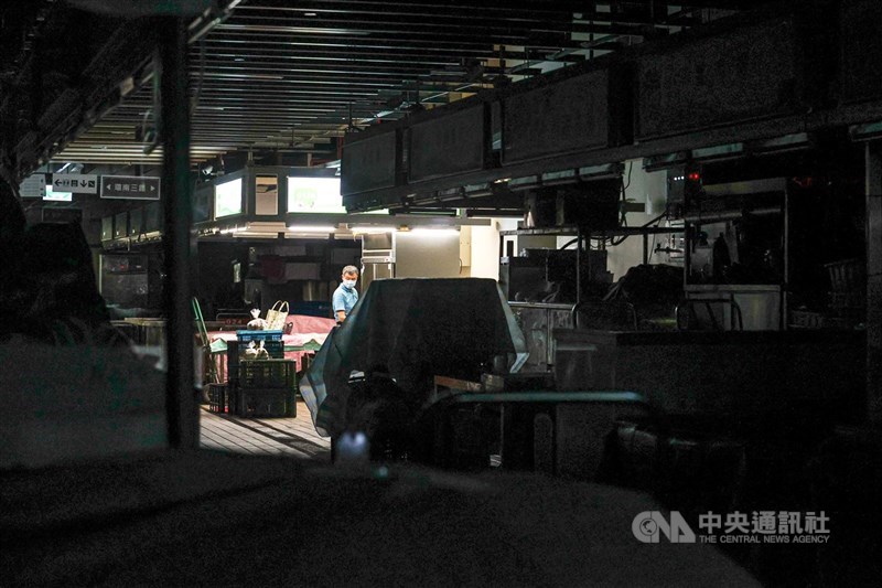 台北市環南市場8日進行大規模篩檢,盼將潛藏在社區的黑數找出來,控制疫情。市場上午關燈休市,僅有零星攤商開著燈整理。中央社記者鄭清元攝 110年7月8日
