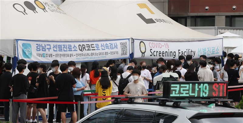 韓國單日確診人數從7日起維持在1200、1300例以上,11日雖降至1100例,但應是受週末採檢人數減少影響。圖為12日首爾江南區篩檢站排隊人潮。(韓聯社)