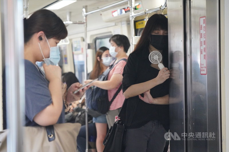 中央流行疫情指揮中心宣布全國三級警戒延長至26日,13日起放寬部分場域規定進行「微解封」。微解封首日,民眾搭乘捷運上班,靠在車廂內閉目養神。中央社記者徐肇昌攝 110年7月13日