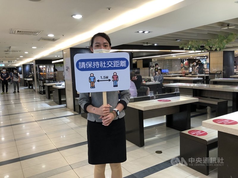 全國COVID-19疫情警戒27日降為2級,台中市有限制開放餐飲內用,百貨公司美食街除設隔板,也有加派人員提醒民眾保持社交安全距離。(業者提供)中央社記者郝雪卿傳真 110年7月27日