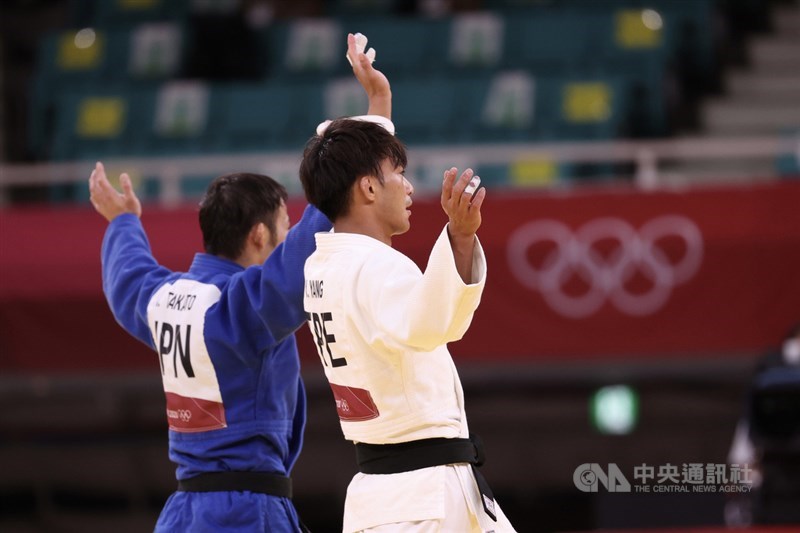 東京奧運男子柔道60公斤級冠軍戰24日晚間登場,由日本好手高藤直壽(藍衣)與台灣「排灣族勇士」楊勇緯(白衣)交手過招,雙方一同向場邊人員揮手致意。中央社記者吳家昇攝 110年7月24日