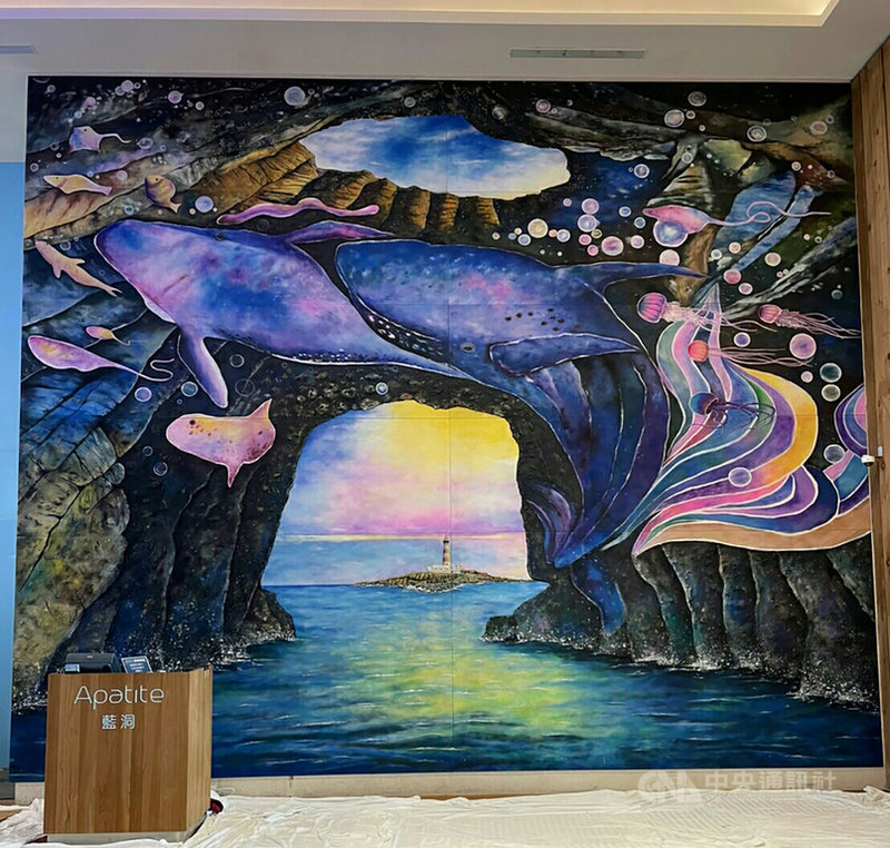 澎湖福朋喜來登酒店巨幅砂畫作品「大自然的禮物–鬼斧神工之藍洞」,16日下午正式揭畫,作品委由澎湖監獄7名收容人創作,從設計理念、構圖靈感、選用材料、實際施作到掛畫作業一一完成,呈現西吉海蝕洞「藍洞」夢幻美景。中央社 110年9月16日