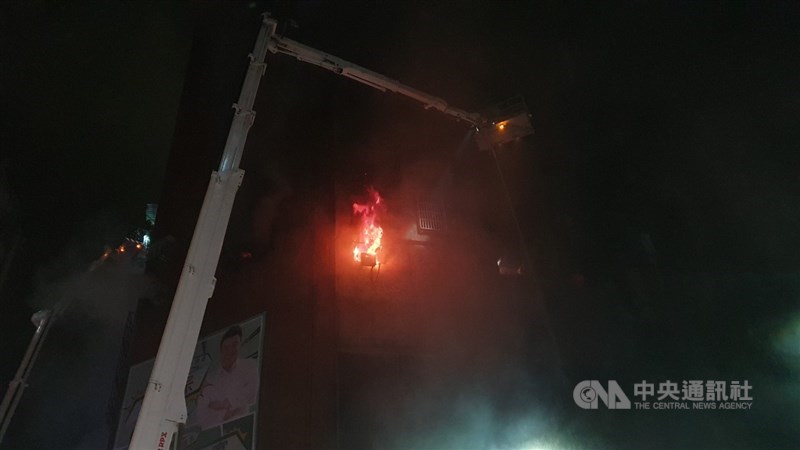 高雄鹽埕區「城中城」大樓14日凌晨發生大火,火舌從1樓一路向上竄燒,消防人員出動雲梯車持續灌救,並搜尋其中住戶。中央社記者洪學廣攝110年10月14日