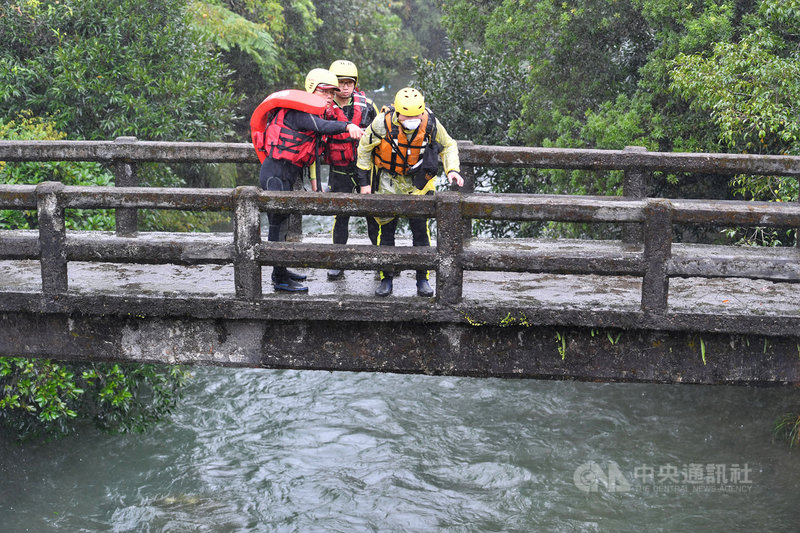新北市雙溪區虎豹潭16日發生自然體驗營民眾落水事件,6人失聯,17日上午陸續尋獲45歲鐘男與9歲蔡姓女童遺體。搜救人員現場討論執行救援任務。中央社記者王飛華攝 110年10月17日