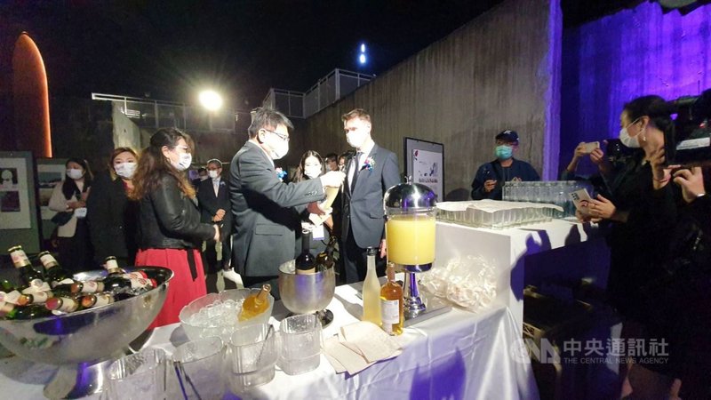 「2021捷克在屏東」2日晚間有一場別開生面的晚宴,屏東縣政府在縣民公園地坑以屏東農特產、小吃設宴款待各國駐台代表,縣長潘孟安(前左2)向捷克駐台代表朗樂(Patrick Rumlar)(前左3)介紹小米酒。中央社記者郭芷瑄攝 110年12月2日