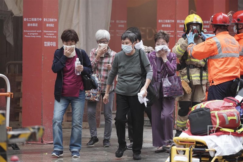 香港銅鑼灣世界貿易中心15日火災，民眾紛紛掩住口鼻趕緊撤離。（立場新聞提供）