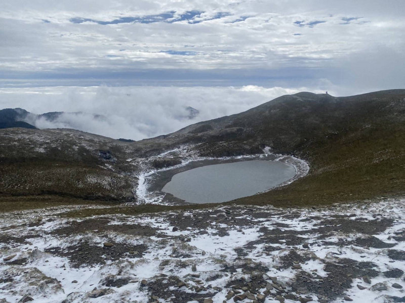冷氣團發威，「天使的眼淚」嘉明湖27日凌晨下起了雪、冰霰，湖的周圍鑲上白邊，山友看到難得景色都直呼幸運。（熊出沒戶外休閒服務企業社提供）中央社記者李先鳳傳真 110年12月27日