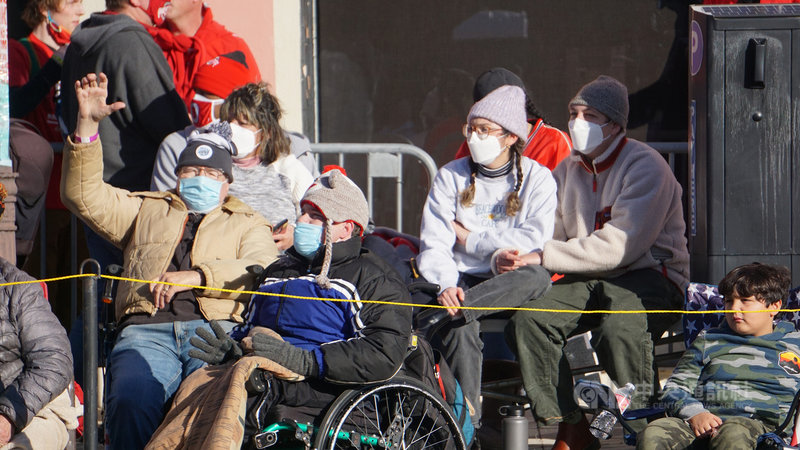 美國新年盛會玫瑰花車遊行(Rose Parade)2022年恢復舉辦,隨著2019冠狀病毒疾病染疫人數再度飆升,觀眾配合主辦單位宣導,戴上口罩看遊行。中央社記者林宏翰洛杉磯攝 111年1月2日