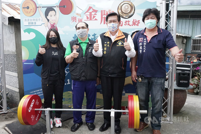 花蓮縣新城鄉公所在奧運舉重金牌教練林敬能(左2)老家前設置裝置藝術及打卡背板,27日熱鬧揭幕,「舉重女神」郭婞淳(左)也特別現身力挺。中央社記者張祈攝 111年1月27日