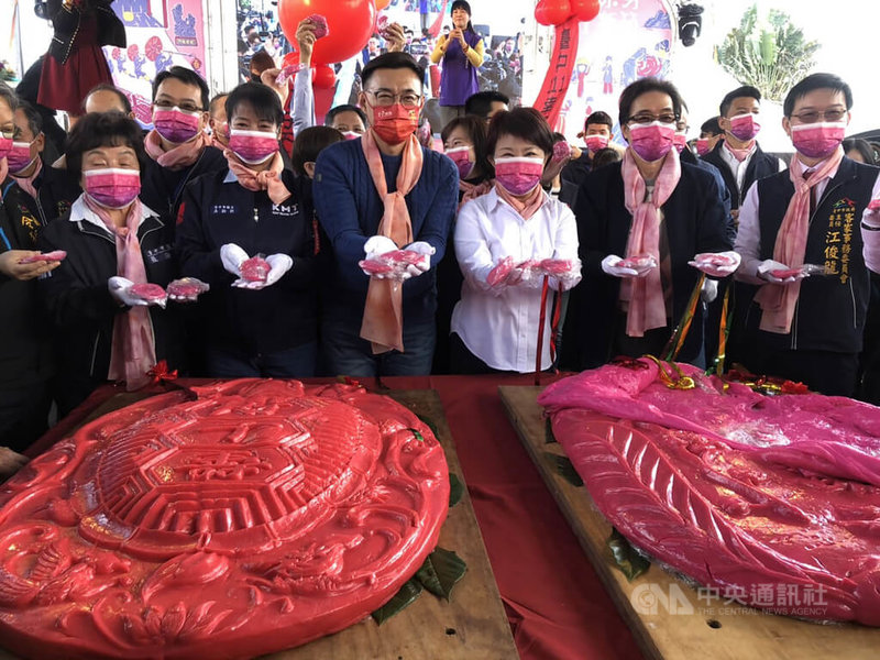 2022台中市東勢區新丁粄節15日在東勢客家文化園區登場，市長盧秀燕（前右3）、立委江啟臣（前左3）等人切開超大桃粄，挖出許多小新丁粄分送給現場民眾。中央社記者趙麗妍攝  111年2月15日