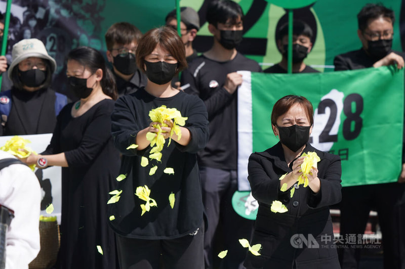 228事件75週年,多個民間團體28日發起第6次「228.0紀念行動」,眾人遊行到行政院後撒下長春花瓣,緬懷、追悼228受難者。中央社記者徐肇昌攝 111年2月28日
