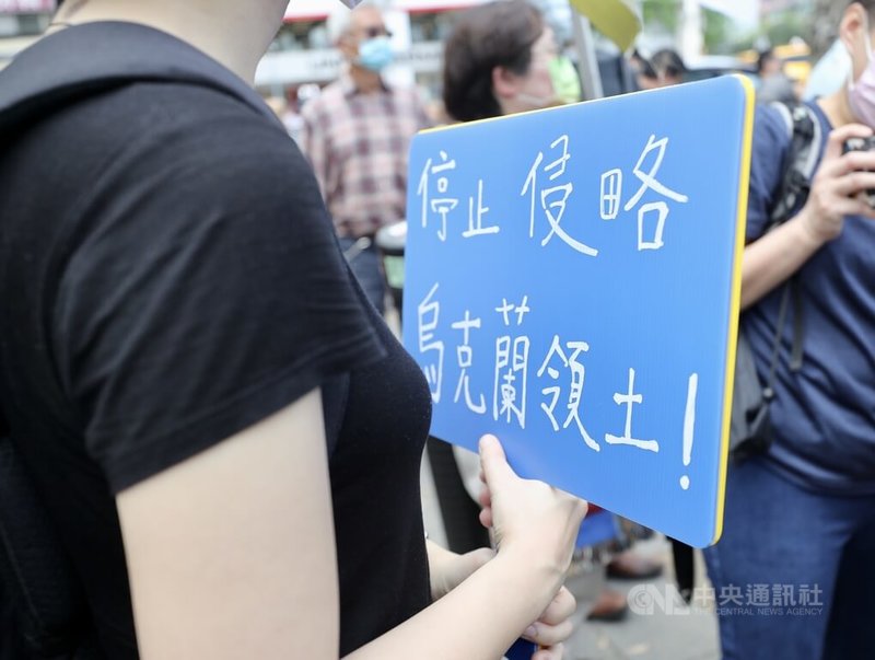 俄烏戰火延燒，一群台灣、烏克蘭、立陶宛、波蘭等國人13日在台北發起「聲援烏克蘭和平大遊行」，參與民眾手持標語，抗議俄羅斯入侵烏克蘭。中央社記者張皓安攝　111年3月13日